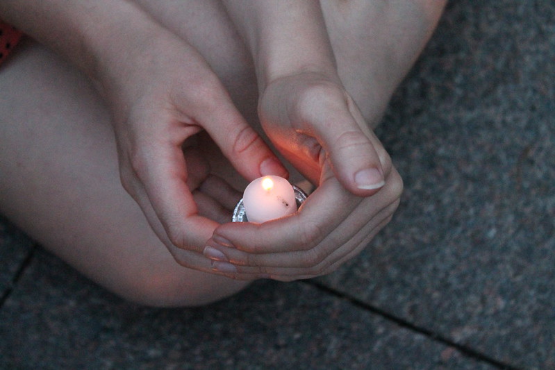 Holding a lit candle