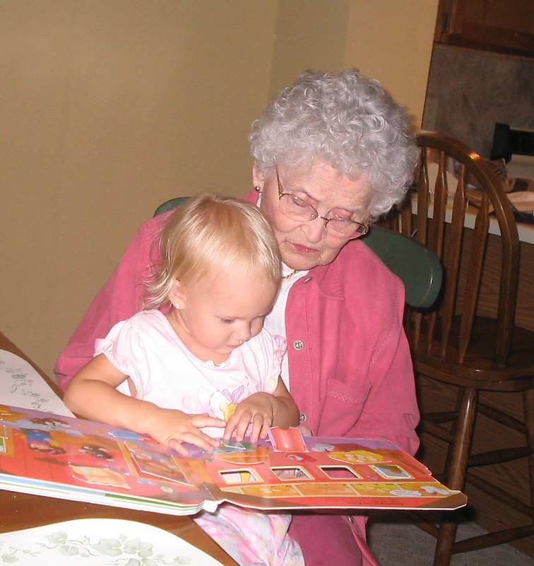 Grandma reading a book to a child