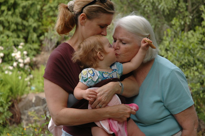 Grandma kissing her granddaughter