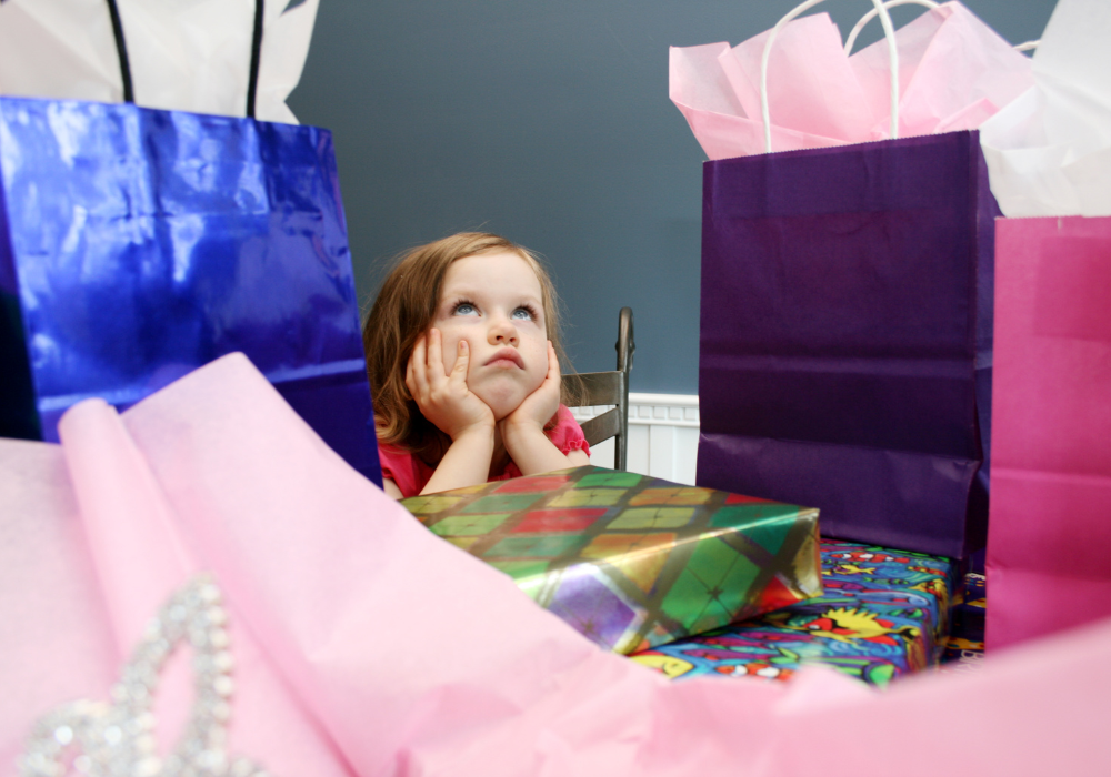 A little girl with a lot of presents