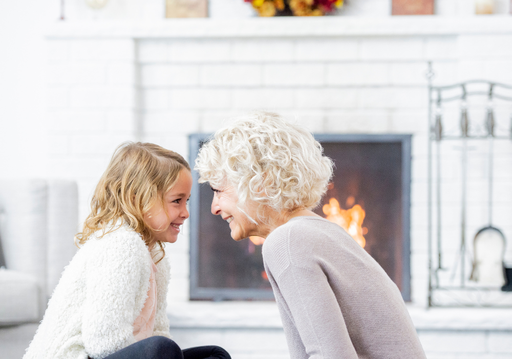 Grandma and granddaughter in front of the fireplace