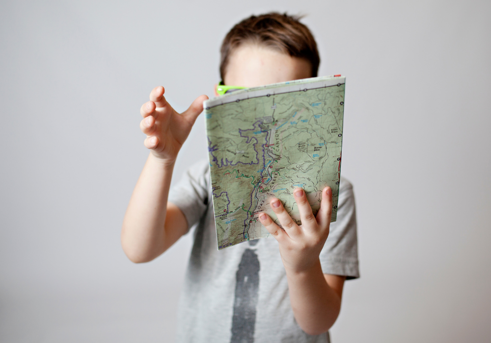Little boy with a foldable road map