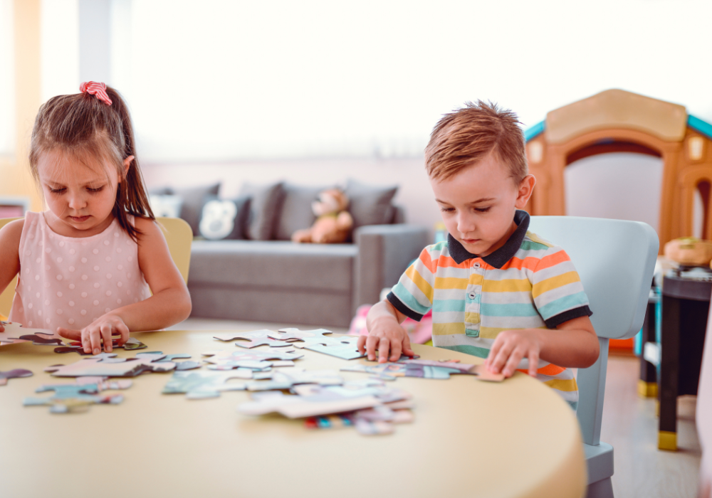 Two children putting together a puzzle