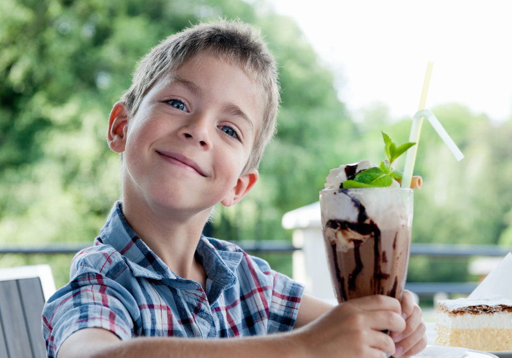 Child smiling with an ice cream sundae