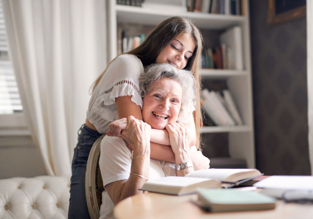 Girl and grandmother smiling with a book