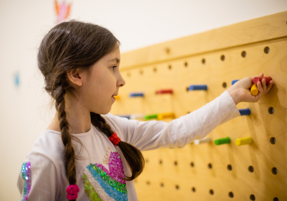 Child with a pegboard