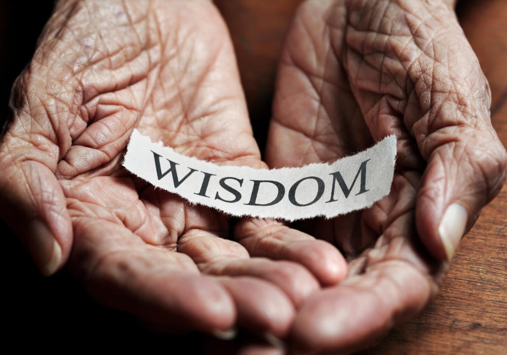 "Wisdom" on a piece of paper in an old person's hands