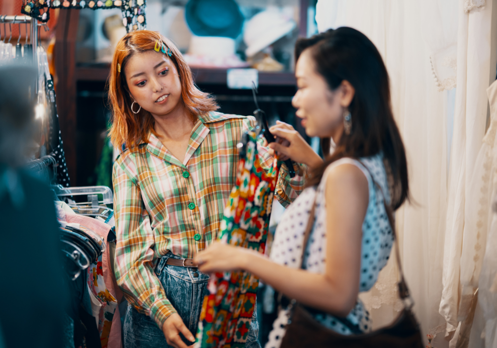 Two women looking at clothes in a store
